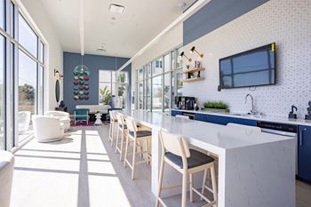 Expansive resident lounge overlooking the pool deck